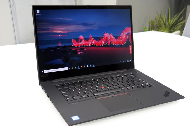 Lenovo laptop sitting on white table.