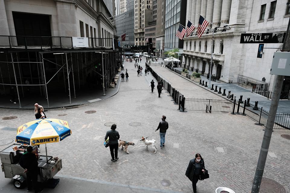 NEW YORK, NEW YORK - MAY 11: People walk by the New York Stock Exchange after global stocks fell as concerns mount that rising inflation will prompt central banks to tighten monetary policy on May 11, 2021 in New York City. By mid afternoon the tech-heavy Nasdaq Composite had lost 0.6% after falling 2.2% at its session low. (Photo by Spencer Platt/Getty Images)